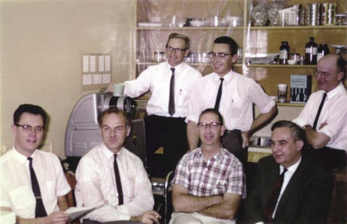 Oh, to be a fly on the wall in this room for the day! Back row from left: Frank McAlpine, Herb Teskey, Guy Shewell. Front row from left: Monty Wood, Dick Vockeroth, Bobbie Peterson, Willi Hennig.